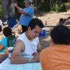 Chief Madeek (Jeff Brown), speaks about the event and the co-management of the parks on Wet'suwet'en Territory. Other members photographed study the area map.